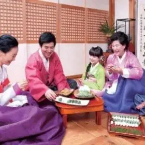 family seated inside around food